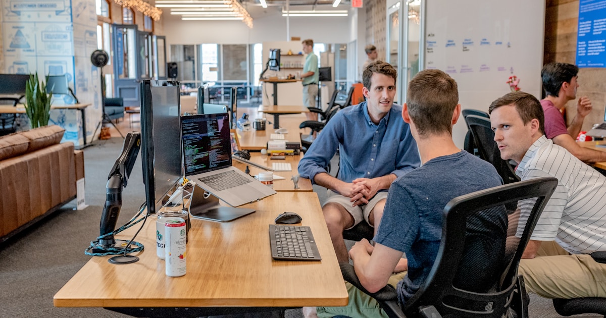 Consultants reviewing notes together at a conference table